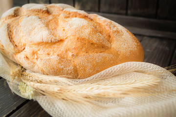traditional bread with ears on rustic wooden table