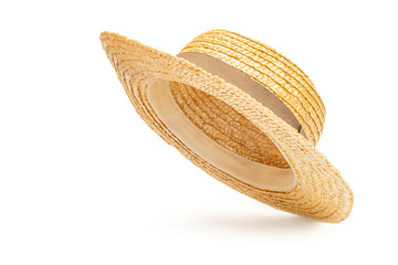 Boater straw hat flying isolated in studio. Concept of fashion clothing accessories and beach...