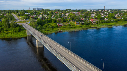 Naklejka na ściany i meble Beautiful panoramic aerial view photo from flying drone over the Jekabpils and Krustpils city bridge. Jēkabpils, Krustpils, Latvija (Series) 