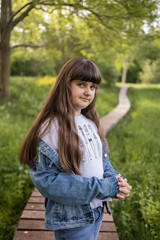 Obraz premium Close up portrait of caucasian smiling girl outside in park