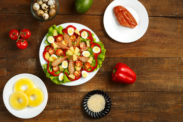 Pan-Asian salad with cherry tomatoes, smoked chicken, pineapple and sesame seeds and a range of ingredients.