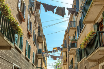 In the middle of Venice, clotheslines with laundry are stretched between the rows of houses