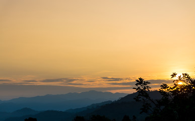 Orange sunrise with mountains in degrade