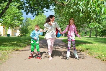 Naklejka na ściany i meble Woman rolls children's hands on roller skates in a Sunny Park in the summer in St. Petersburg