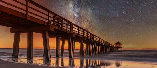 Sunset on the beach. Old Naples Pier, Florida, America. Travel concept.