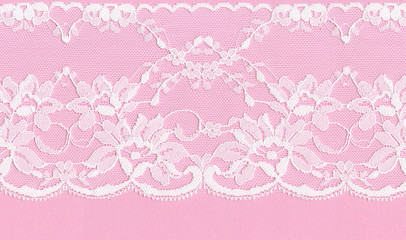 Beautiful  white floral lace on a pink background.