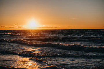 photo of beach waves at sunset time