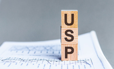 USP - Unique Selling Proposition word concept on cubes