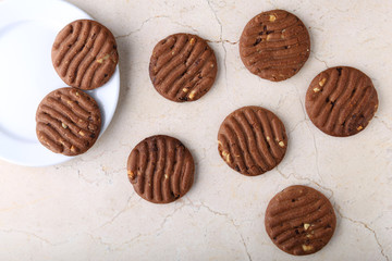 Flat lay composition with chocolate cookies and space for text on marble background