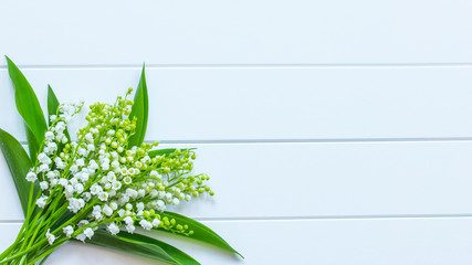 bouquet of lilies of the valley on a white background top view. background with lilies of the valley. lilies of the valley copy space. holiday card with white flowers. © Nataliya