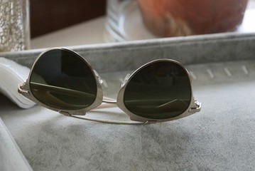 one brown sunglasses lie on a gray table