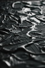 Acrylic black paint close-up. Texture background