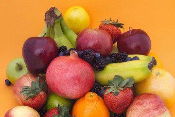 many fruits orange background still life organic healthy eating