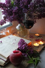 still life with flowers and wine. Still life with lilac and wine. Romantic atmosphere. lilac bouquet