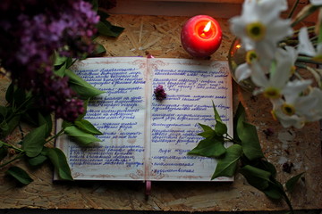 still life with candles. old book and candle. Flowers with candles