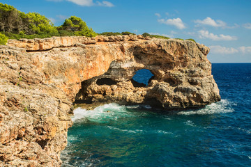 Fototapeta na wymiar View on rocks with hole and deep blue sea.Mallorca Island, Spain