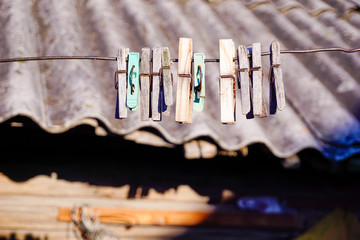 clothespins hang on a rope in the yard