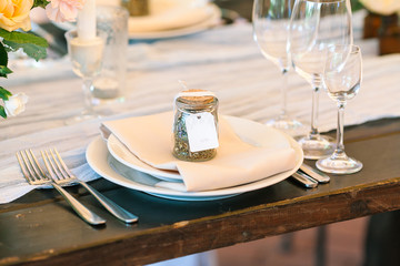 Close-up table setting - a set of dishes - plates of boaklahs and appliances laid out in a certain order on a wooden table.