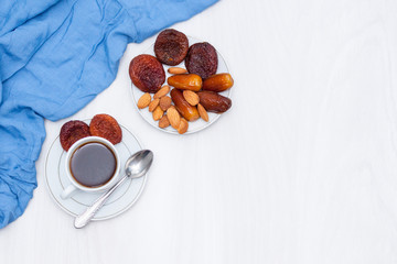 Healthy breakfast or snack concept. Black coffee, dried fruits. Copy space. Flat lay.
