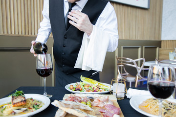 Waiter Pouring Wine into Wine Glass Horizontal