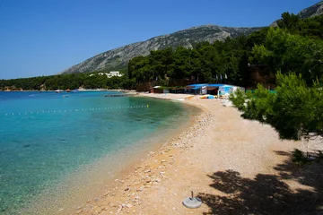 Foto op Canvas Small beach on the island of Brac in Croatia, near Bol - Seaside restaurants and swimmers in the Adriatic Sea © Alexandre ROSA