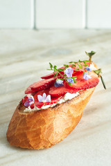 Assorted delicious bruschetta with tomatoes, strawberries, avocado, radish, Camembert and prosciutto. Close-up, top view, on a white background