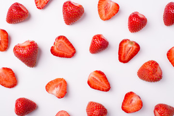Top above overhead view photo of whole and cut strawberries isolated on white background