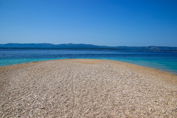 Fototapeta na wymiar Zlatni Rat sandbar near Bol on the island of Brac in Croatia - Mirror beach on a sand peninsula with turquoise waters in the Adriatic Sea
