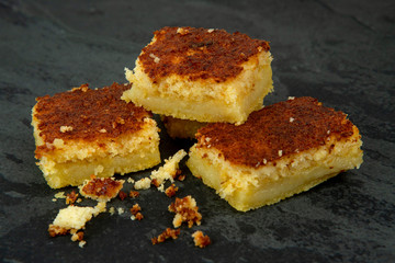 Pieces of creamy cornmeal cake. Traditional Brazilian treats made of corn