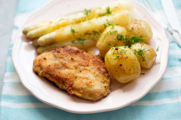 Breaded pork chops (schabowy) with baby potatoes and white asparagus with dill 