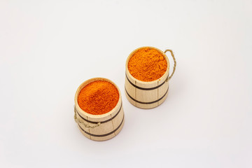 Two types of Hungarian paprika powder, hot and sweet, isolated on white background