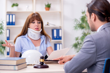 Young injured woman and male lawyer in the courtroom