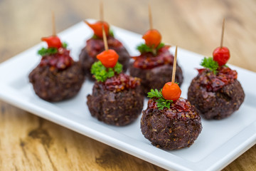 Meat croquette served with pepper. This on the wooden table