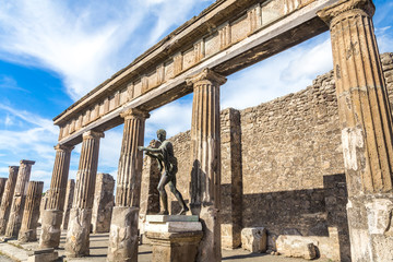 Pompeii in Italy, ruins of the antique Temple of Apollo with bronze Apollo statue, Naples.