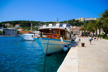 Waterfront promenade on the island of Hvar in Croatia - Luxury yacht moored in an old port of the...