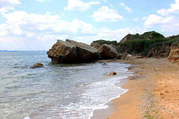 Fototapeta na wymiar Beautiful wild Beach Fontanka near Odessa. Yellow and red sandstone cliffs are located on the seafront. Sunny day