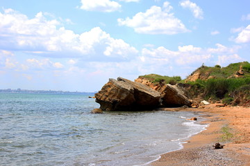 Fototapeta premium Beautiful wild Beach Fontanka near Odessa. Yellow and red sandstone cliffs are located on the seafront. Sunny day