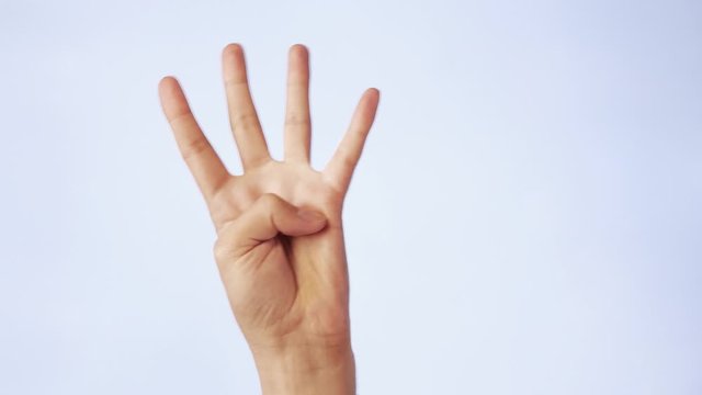 closeup male hand isolated on a white background four fingers raised up