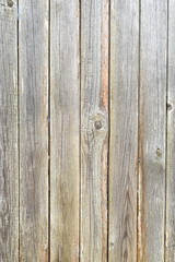 Old plank wooden unpainted gray fence.