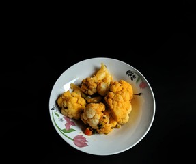 Stewed cauliflower dish on black background. typical food of Guatemala