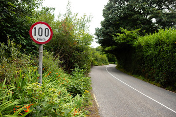 Speed limit 100 kilometers per hour sign A posted Aon country road in Ireland