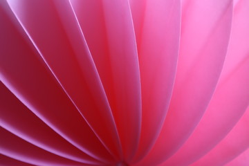 Pink abstract background with bizarre pattern. Soft lines transition light and dark shadows. Photos with soft focus.