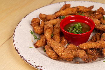 Portion of fried chicken with sauce