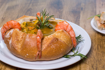 seafood moqueca served inside Italian bread
