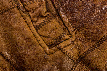 Old vintage genuine soft brown leather texture background, top layer with pores and scratches, macro, close-up