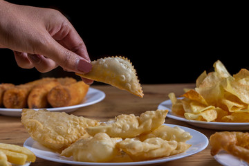 hand holding pastel Brazilian typical snack