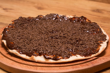 chocolate pizza on wooden background