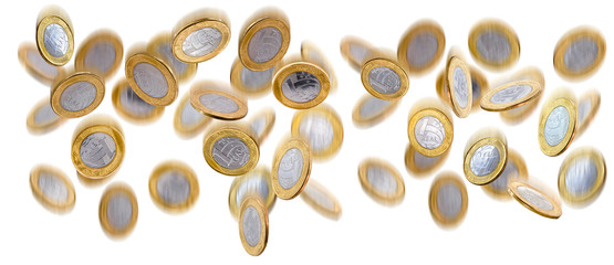 Falling one brazilian real coins isolated on white background