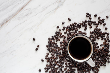 Black coffee with roasted beans on  marble cream white