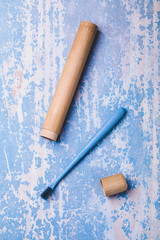 Bamboo toothbrush on blue wood background. Concept eco friendly